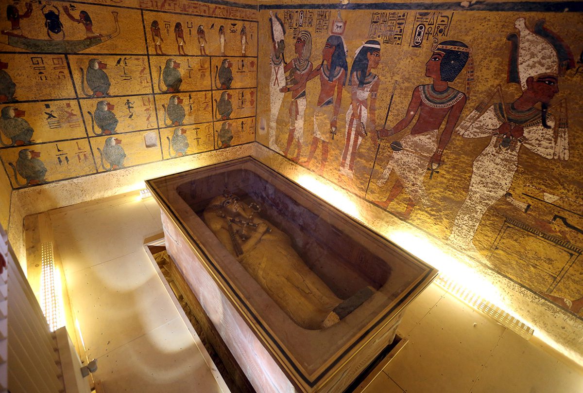 An Egyptian tomb featuring a decorated sarcophagus in the center. The walls are adorned with ancient Egyptian artwork and hieroglyphics, illuminated by soft, warm lighting. The artwork depicts various figures and symbols. Waterproofing Company | Basement Leak Repair | City Wide Group | Professional waterproofing company and basement leak repair in Toronto since 1961. | https://www.citywidegroup.com | +1 416-283-5500