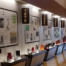 A hallway exhibit showcasing the illuminating history of lanterns, with panels labeled 1970, 1980, 1990, and 2000. Below them are displayed various models on a polished floor. On the right wall, a logo proudly reads City Wide Group Inc, making headlines without words. Waterproofing Company | Basement Leak Repair | City Wide Group | Professional waterproofing company and basement leak repair in Toronto since 1961. | https://www.citywidegroup.com | +1 416-283-5500