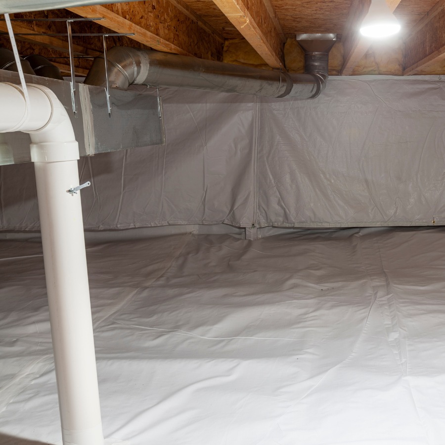 A basement showcases white vapor barriers on the floor and walls, with exposed wooden beams gracing the ceiling alongside ductwork and a PVC pipe. Illuminated from above, this space highlights City Wide Groups expertise as a basement waterproofing company. Waterproofing Company | Basement Leak Repair | City Wide Group | Professional waterproofing company and basement leak repair in Toronto since 1961. | https://www.citywidegroup.com | +1 416-283-5500
