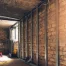 Homeowner reviewing a basement underpinning permit in Toronto with structural plans beside an exposed foundation wall