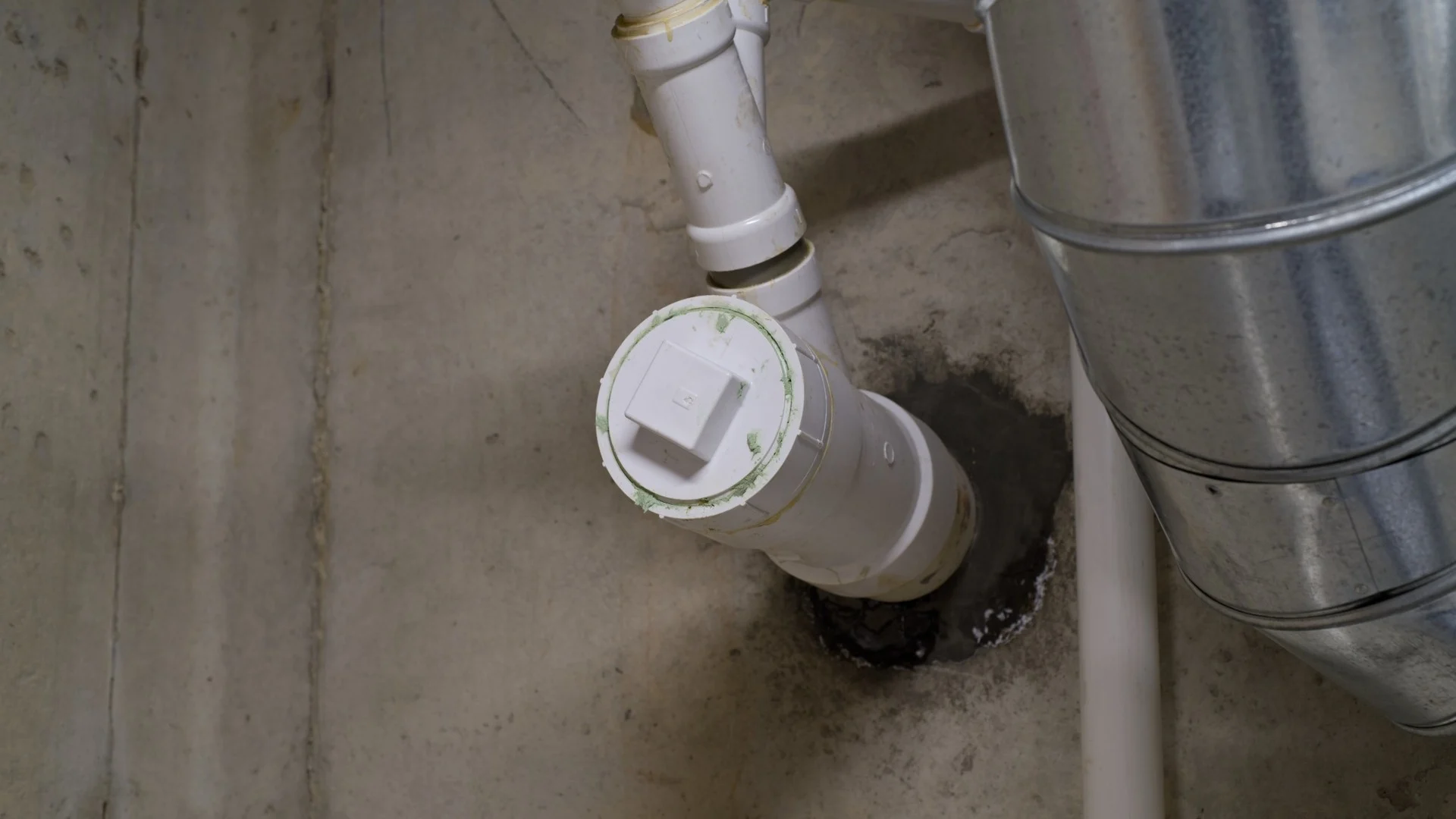 Water leaking around basement pipe penetration in a concrete foundation wall
